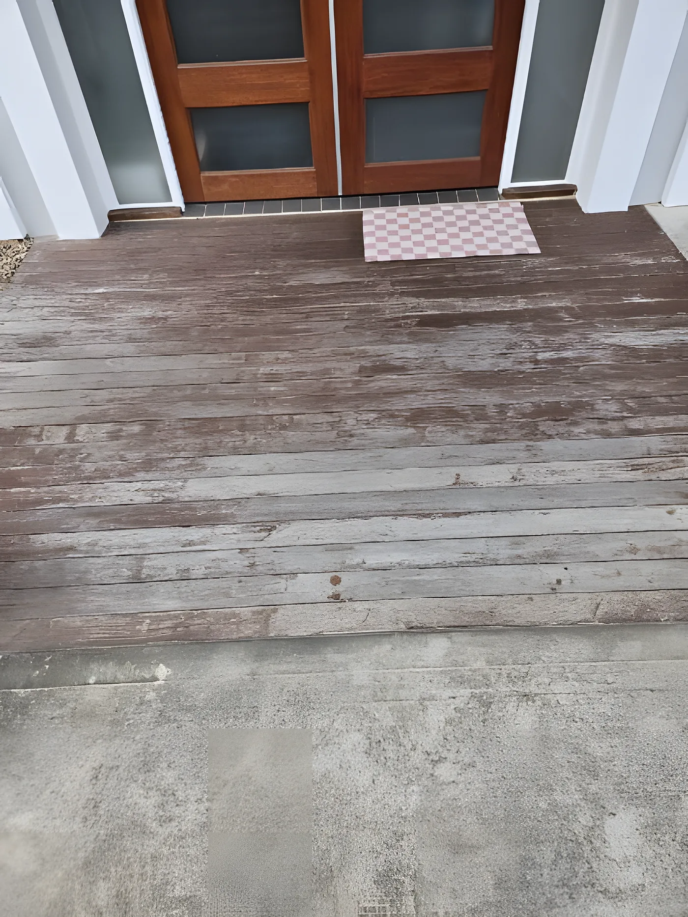 A weathered timber deck before restoration