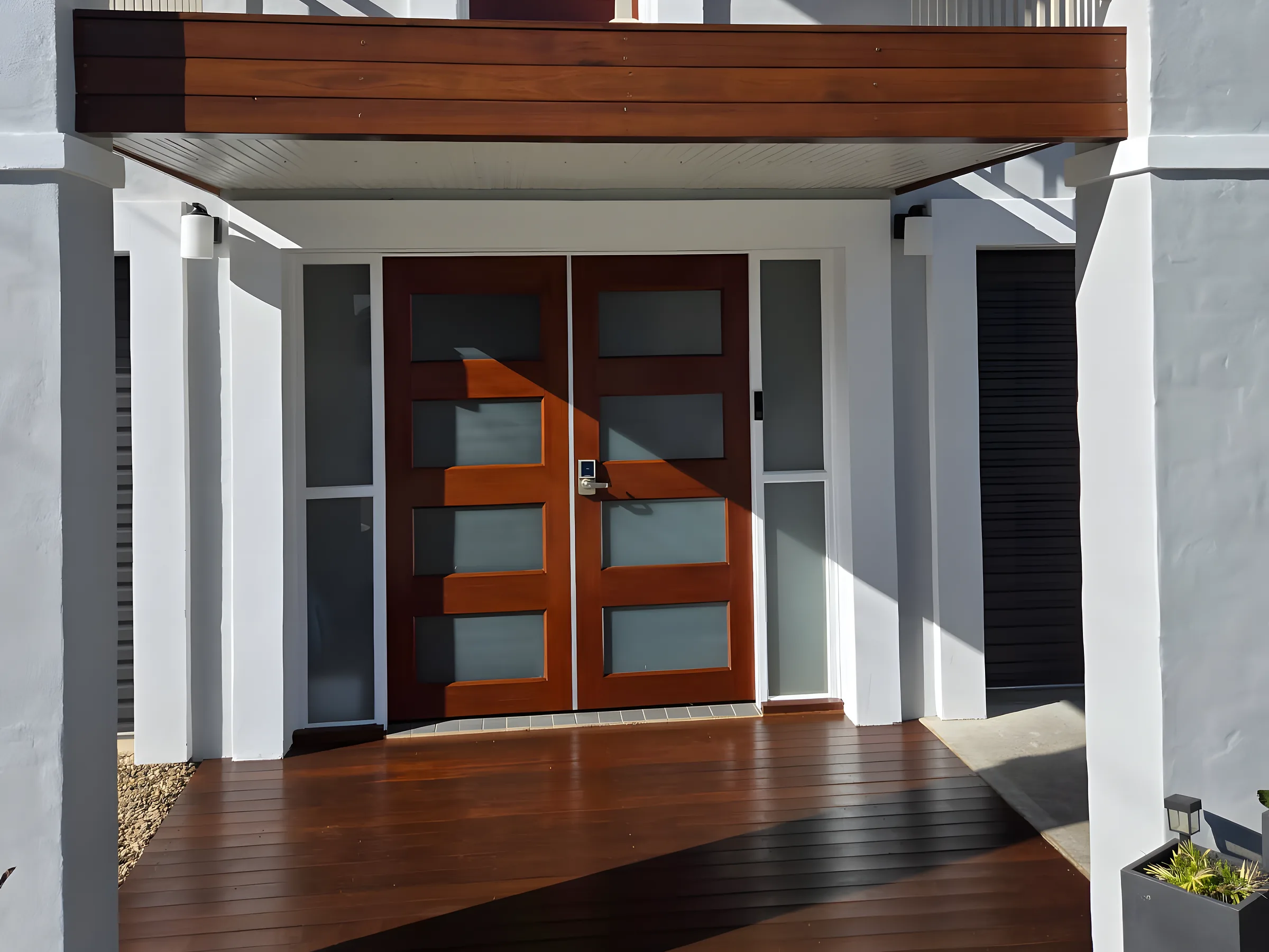 A restored merbau front deck and timber entry doors, freshly oiled