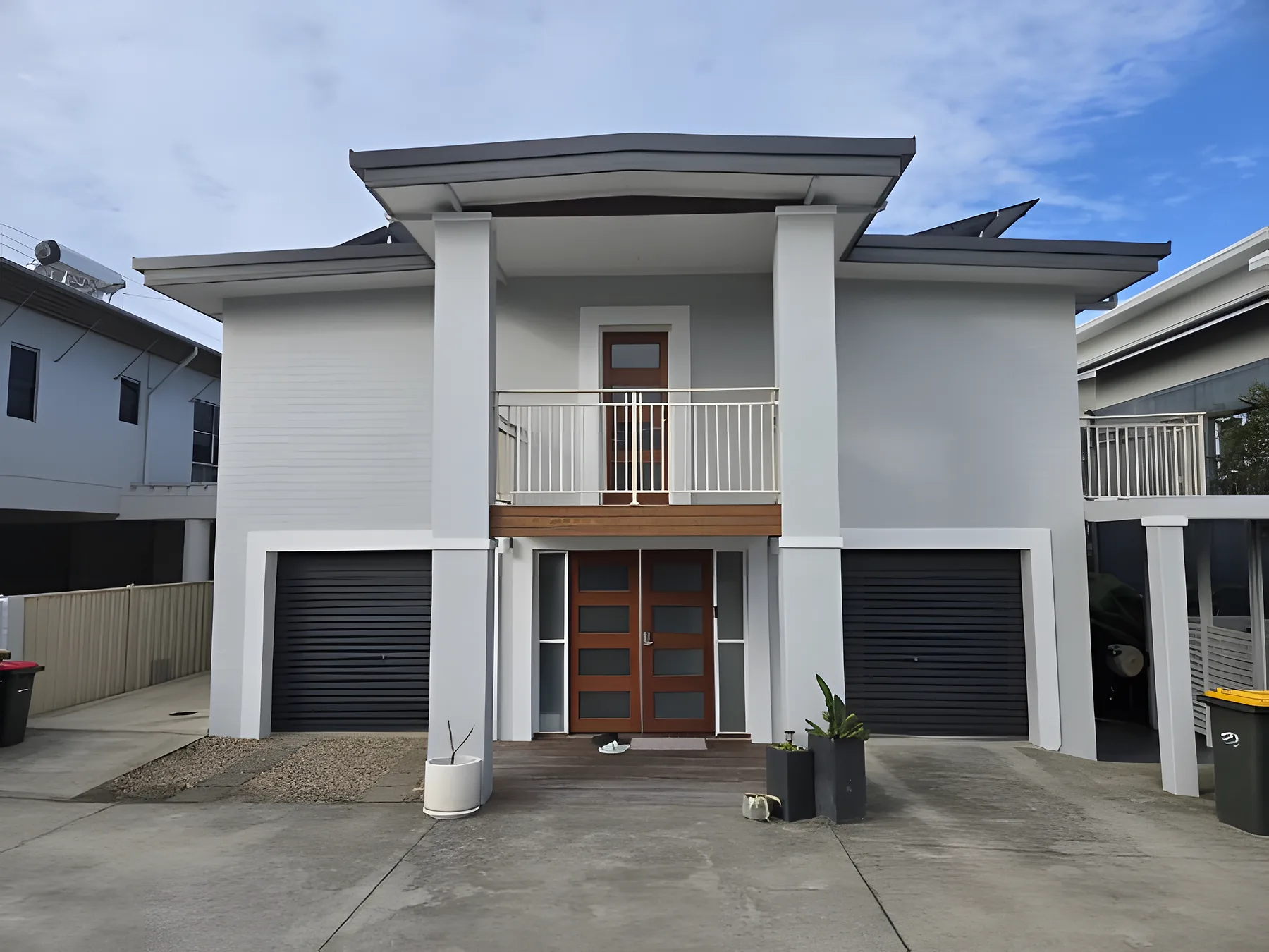 A two storey rendered townhouse in Dulux Lexicon