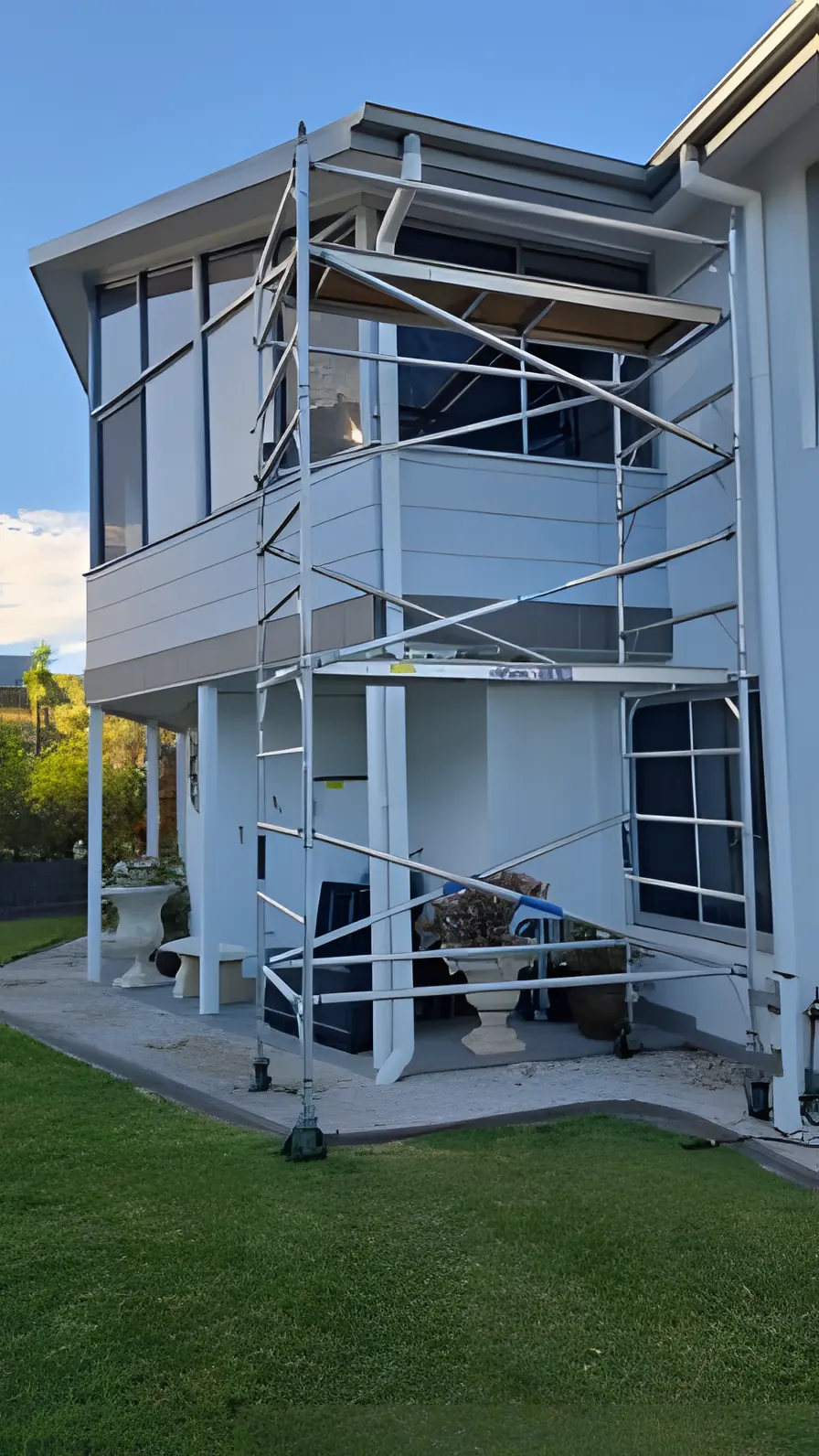 A scaffold tower up against a two storey house exterior